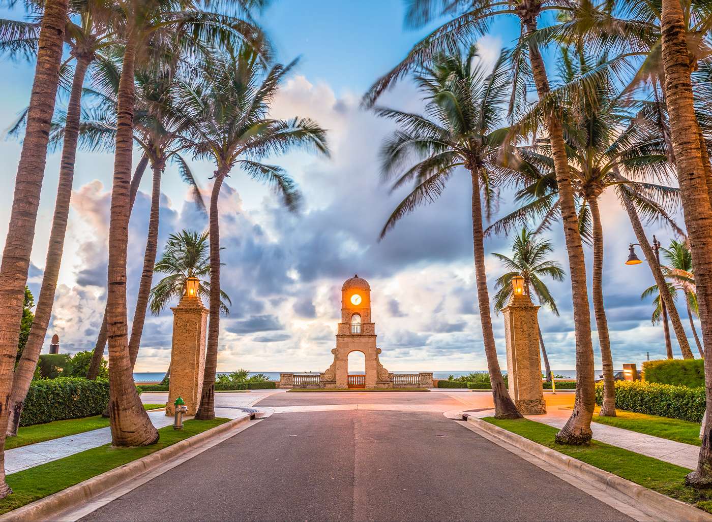 A palm-lined drive leading to the Worth Avenue clock tower at dusk
